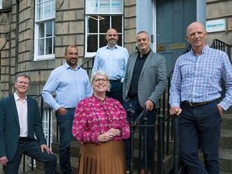 User Vision team standing outside the company's Edinburgh office
